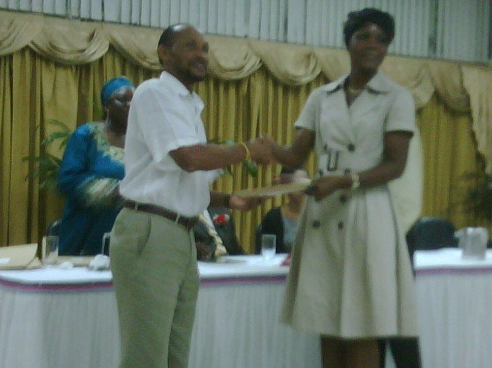 Kadine Reynolds receiving a Project Management certificate at The University of the West Indies Open Campus