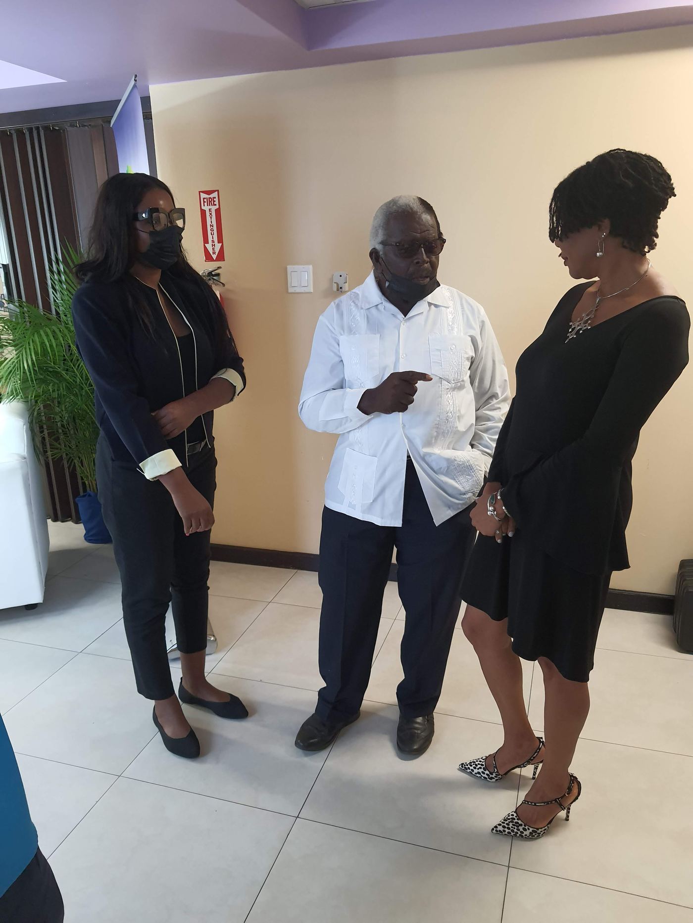 Kadine Reynolds in conversation with Pearnel Charles Sr and a colleague