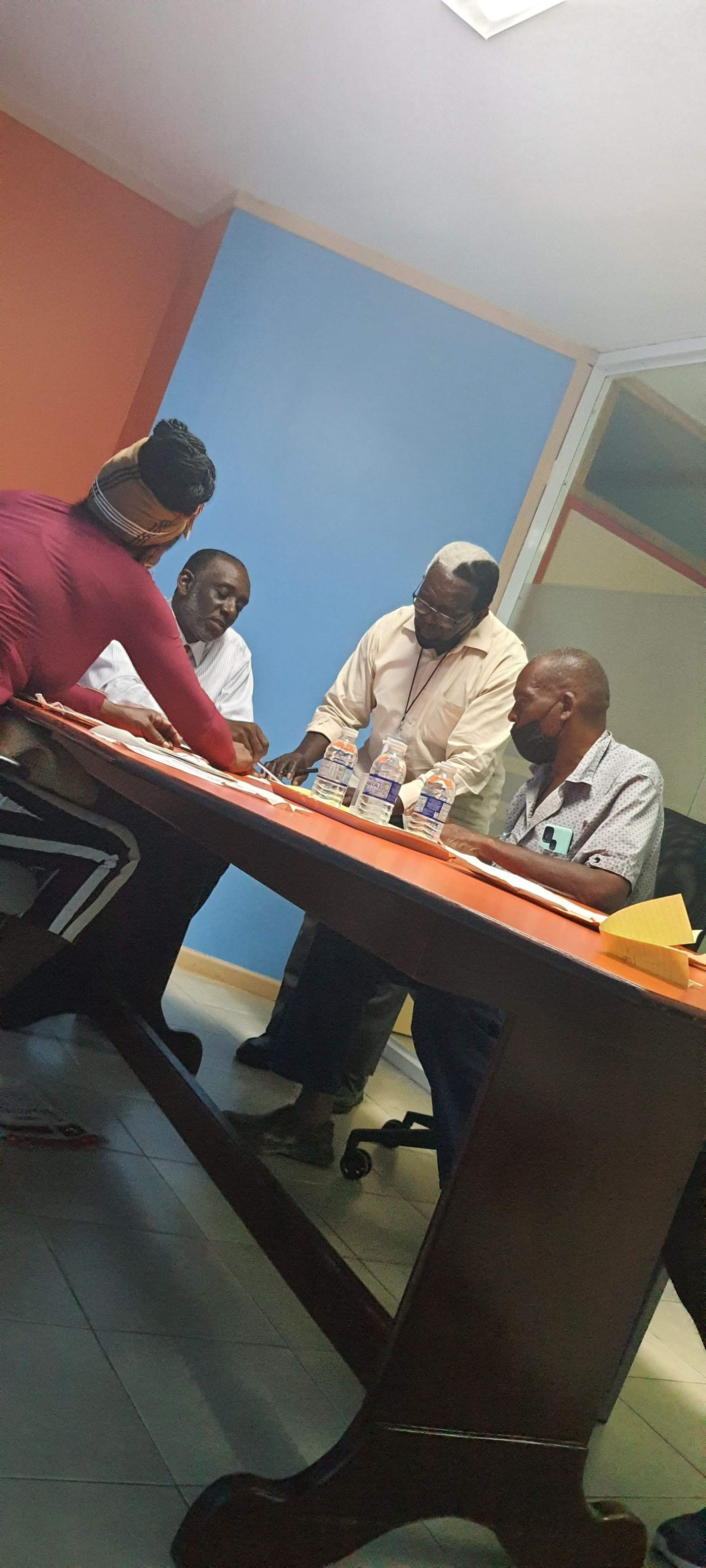 A mediation session in progress at a table in Clarendon, Jamaica
